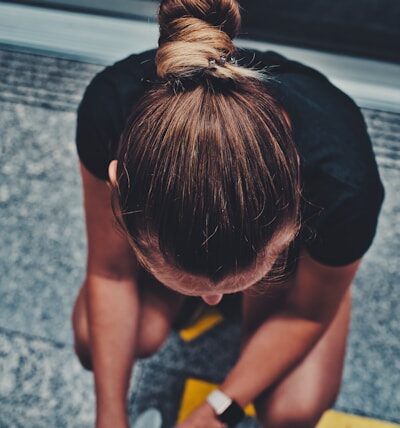 woman over 40 walking outdoors with heart rate monitor