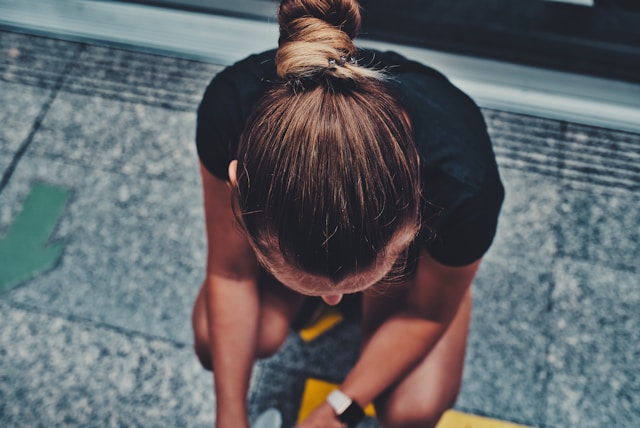 woman over 40 walking outdoors with heart rate monitor